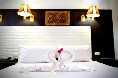 a bed with a pair of pretzelpretending to look like snakes at Wan Wan Place in Ao Nang Beach