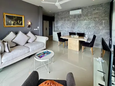 a living room with a couch and a table at Klong Muang Beach Apartment in Klong Muang Beach