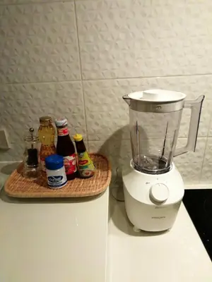 a blender sitting on top of a counter with condiments at Klong Muang Beach Apartment in Klong Muang Beach
