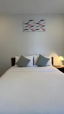 a white bed with two pillows in a bedroom at 3B Apartment-SHA Extra Plus in Kamala Beach