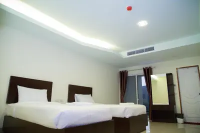 a bedroom with two beds with white sheets at Smile Residence in Rawai Beach