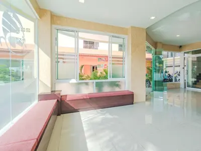 a lobby with a red bench and a window at Smile Residence in Rawai Beach