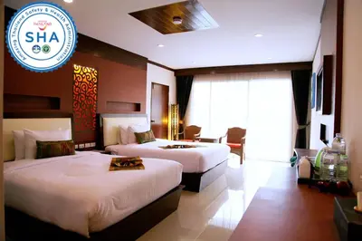 a hotel room with two beds and a sign at Chivatara Resort Bang Tao Beach Phuket - SHA in Bang Tao Beach