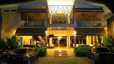 a building with two cars parked in front of it at Chivatara Resort Bang Tao Beach Phuket - SHA in Bang Tao Beach