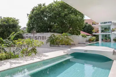a swimming pool next to a building at Wabi Sabi Boutique Hotel - SHA Extra Plus in Kamala Beach