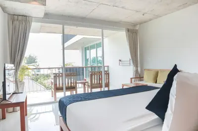 a bedroom with a bed and a balcony at Wabi Sabi Boutique Hotel - SHA Extra Plus in Kamala Beach