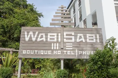 a sign in front of a building that says waldo sidx at Wabi Sabi Boutique Hotel - SHA Extra Plus in Kamala Beach