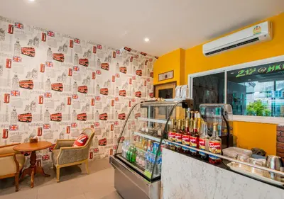 a fast food restaurant with a wall covered in paper at 217@HKT in Phuket Town