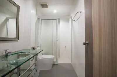 a bathroom with a toilet and a sink and a mirror at 217@HKT in Phuket Town