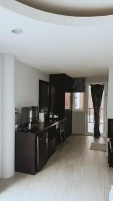 a living room with a kitchen with a counter top at Naiyang Seaview Place Resort in Nai Yang Beach