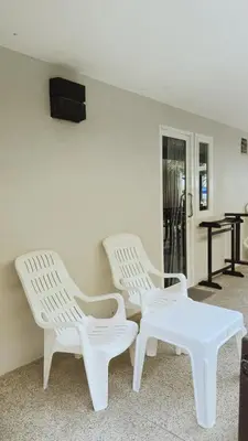 two white chairs and a table in a room at Naiyang Seaview Place Resort in Nai Yang Beach