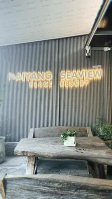 a wooden table with a potted plant on top of it at Naiyang Seaview Place Resort in Nai Yang Beach