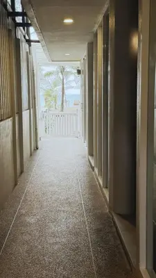 a hallway of a house with a white fence at Naiyang Seaview Place Resort in Nai Yang Beach