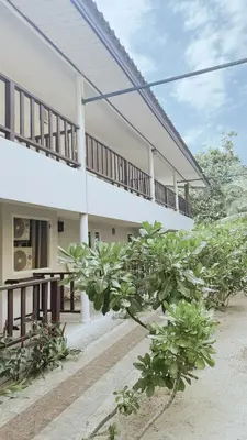 a building with some plants in front of it at Naiyang Seaview Place Resort in Nai Yang Beach