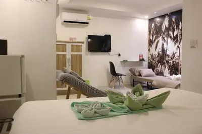 a room with a table and a living room at 1715 House - White Rhino in Rawai Beach