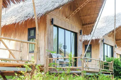 a bamboo house with a thatched roof at Anyavee Krabi Beach Resort in Klong Muang Beach