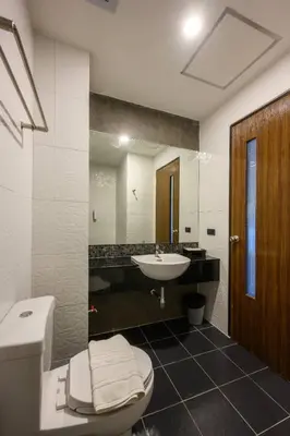 a bathroom with a toilet and a sink at Phuket Airport Place in Nai Yang Beach