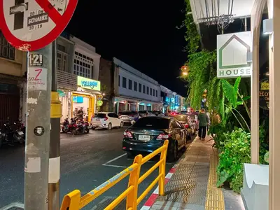 a city street at night with cars parked on the street at Chino Town at Yaowarat Phuket - SHA Plus in Phuket Town