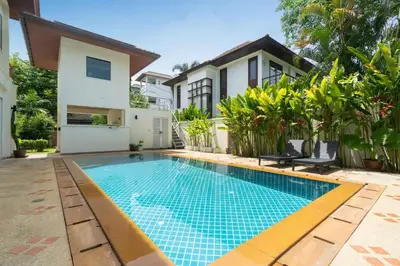 a swimming pool in the backyard of a villa at Baan Kaja Villa by Lofty in Surin Beach