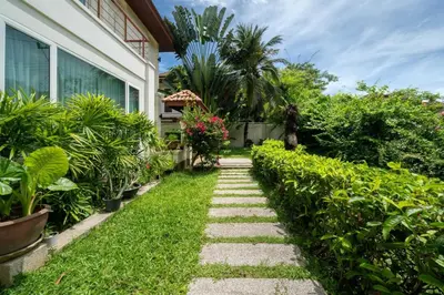 a garden path leading to a house at Baan Kaja Villa by Lofty in Surin Beach