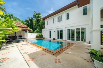 a swimming pool in the backyard of a house at Baan Kaja Villa by Lofty in Surin Beach