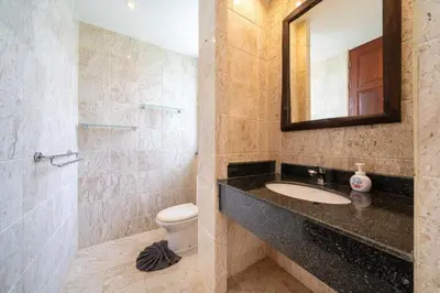 a bathroom with a sink and a toilet and a mirror at Baan Kaja Villa by Lofty in Surin Beach
