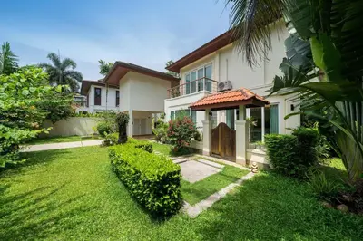 a house with a yard in front of it at Baan Kaja Villa by Lofty in Surin Beach