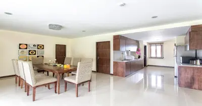 a kitchen and dining room with a table and chairs at The Lai Thai Luxury Condominiums in Ao Nang Beach
