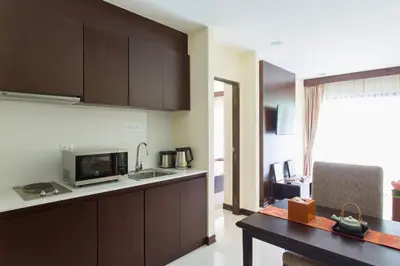 a kitchen with a counter top and a microwave at The Lai Thai Luxury Condominiums in Ao Nang Beach