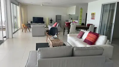 a living room with two couches and a table at Kata Top Villas in Kata Beach
