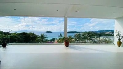 a large white room with a view of the ocean at Kata Top Villas in Kata Beach