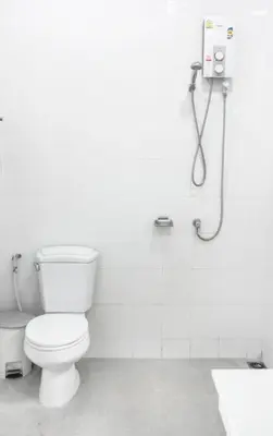 a white bathroom with a toilet and a shower at Kata Top Villas in Kata Beach