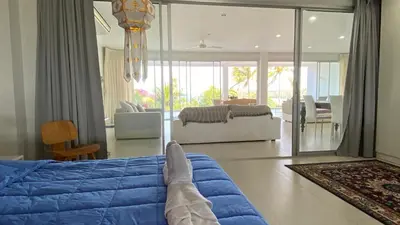 a person laying on a bed in a living room at Kata Top Villas in Kata Beach