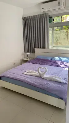 a bed with two white hearts on it at Kata Top Villas in Kata Beach