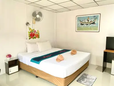 a bedroom with two beds and a tv at JJ karon beach hotel in Karon Beach