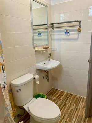 a small bathroom with a toilet and a sink at JJ karon beach hotel in Karon Beach