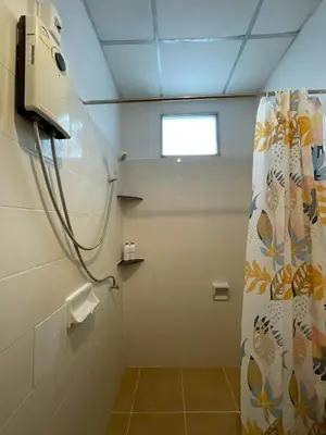 a bathroom with a shower with a shower curtain at JJ karon beach hotel in Karon Beach