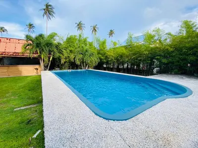 a swimming pool with blue water in a yard at Phi Phi Little Star Resort in Phi Phi Don