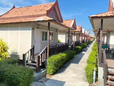 a row of houses with benches on a street at Phi Phi Little Star Resort in Phi Phi Don