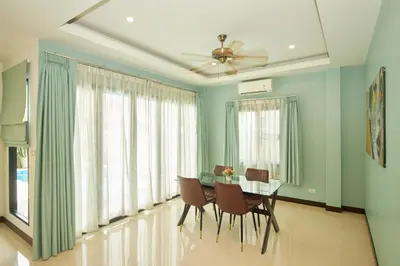 a dining room with a glass table and chairs at Baan Ping Tara Private Pool Villa in Ao Nang Beach