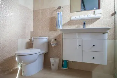a bathroom with a white toilet and a sink at Baan Ping Tara Private Pool Villa in Ao Nang Beach