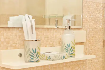 a bathroom sink with a bottle of soap and a mirror at Baan Ping Tara Private Pool Villa in Ao Nang Beach
