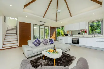 a living room with a couch and a table at Laem Ka Residence by Tropiclook in Rawai Beach