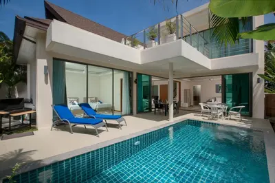 a villa with a swimming pool and a house at Laem Ka Residence by Tropiclook in Rawai Beach