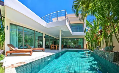 a villa with a swimming pool and a house at Laem Ka Residence by Tropiclook in Rawai Beach