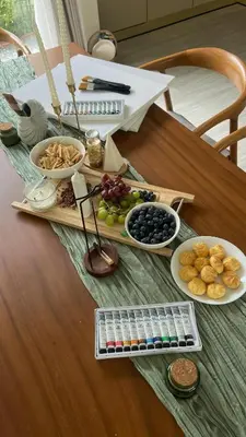 a table with plates of food on a table at La Ville Phuket Pool Villa in Nai Yang Beach
