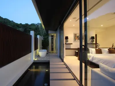 a room with a tub and a bed and a bedroom at Villa Saan - SHA Extra Plus in Kamala Beach