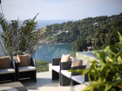 a balcony with chairs and a view of the ocean at Villa Saan - SHA Extra Plus in Kamala Beach