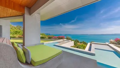 a view of the ocean from the balcony of a house at Villa Leelawadee in Por Bay