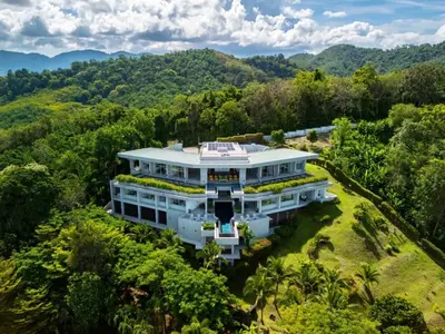 an aerial view of a white house in the forest at Villa Leelawadee in Por Bay